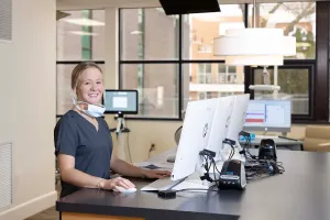 Staff posing with computer