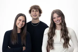 Three young adults posing and smiling