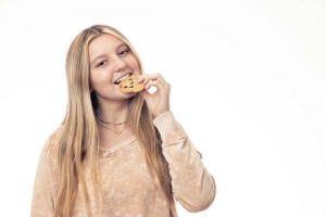 Teen girl eating a cookie
