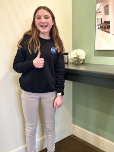 Girl giving thumbs up after treatment